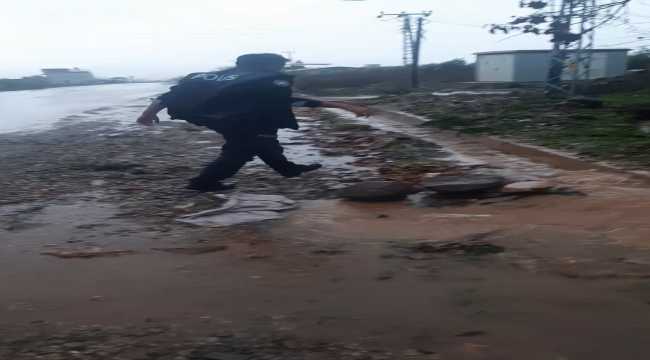 Hatay'da yağış nedeniyle tıkanan su kanalını polis memuru açtı